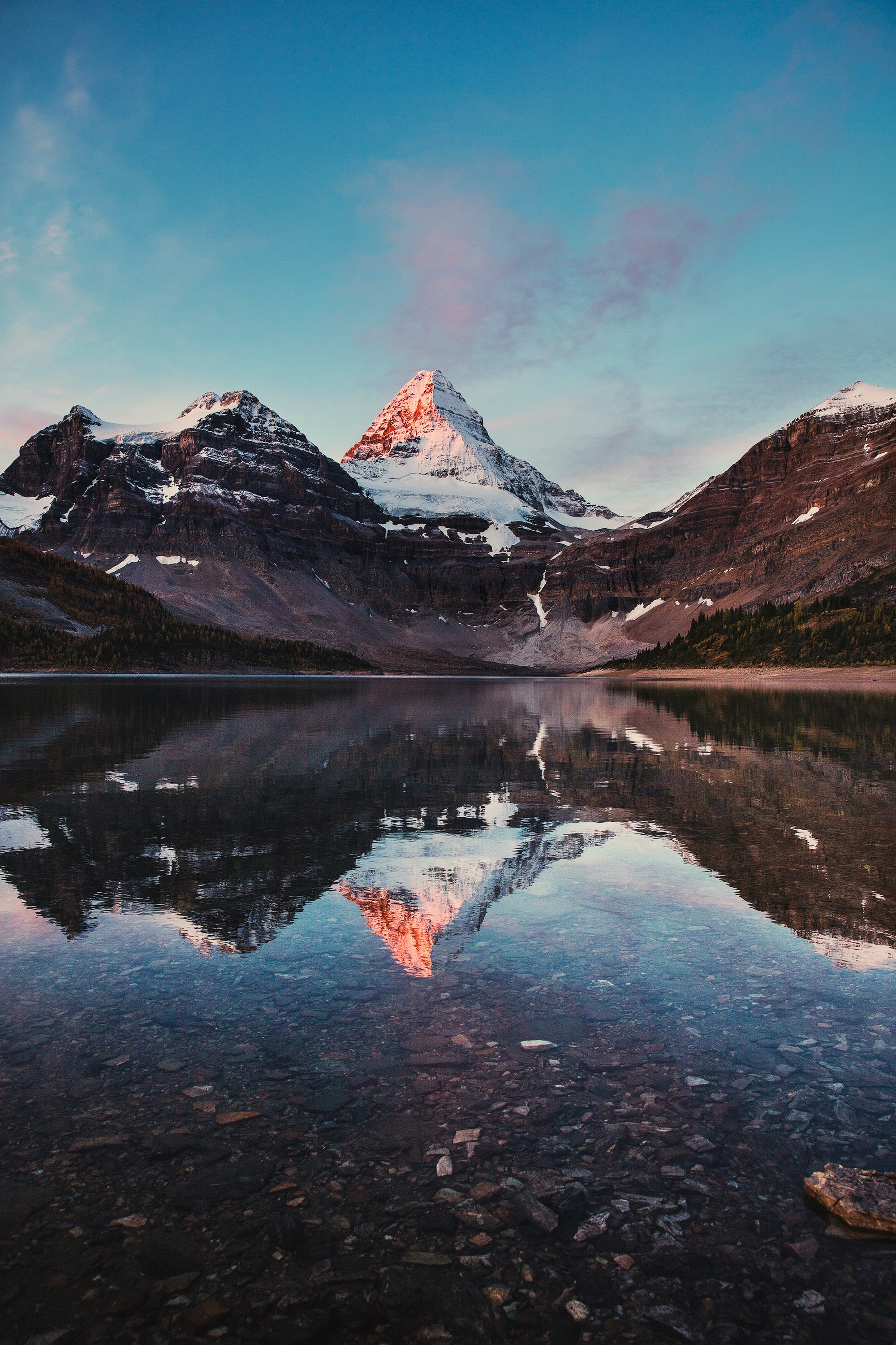 lake near snow covered mountain during daytime