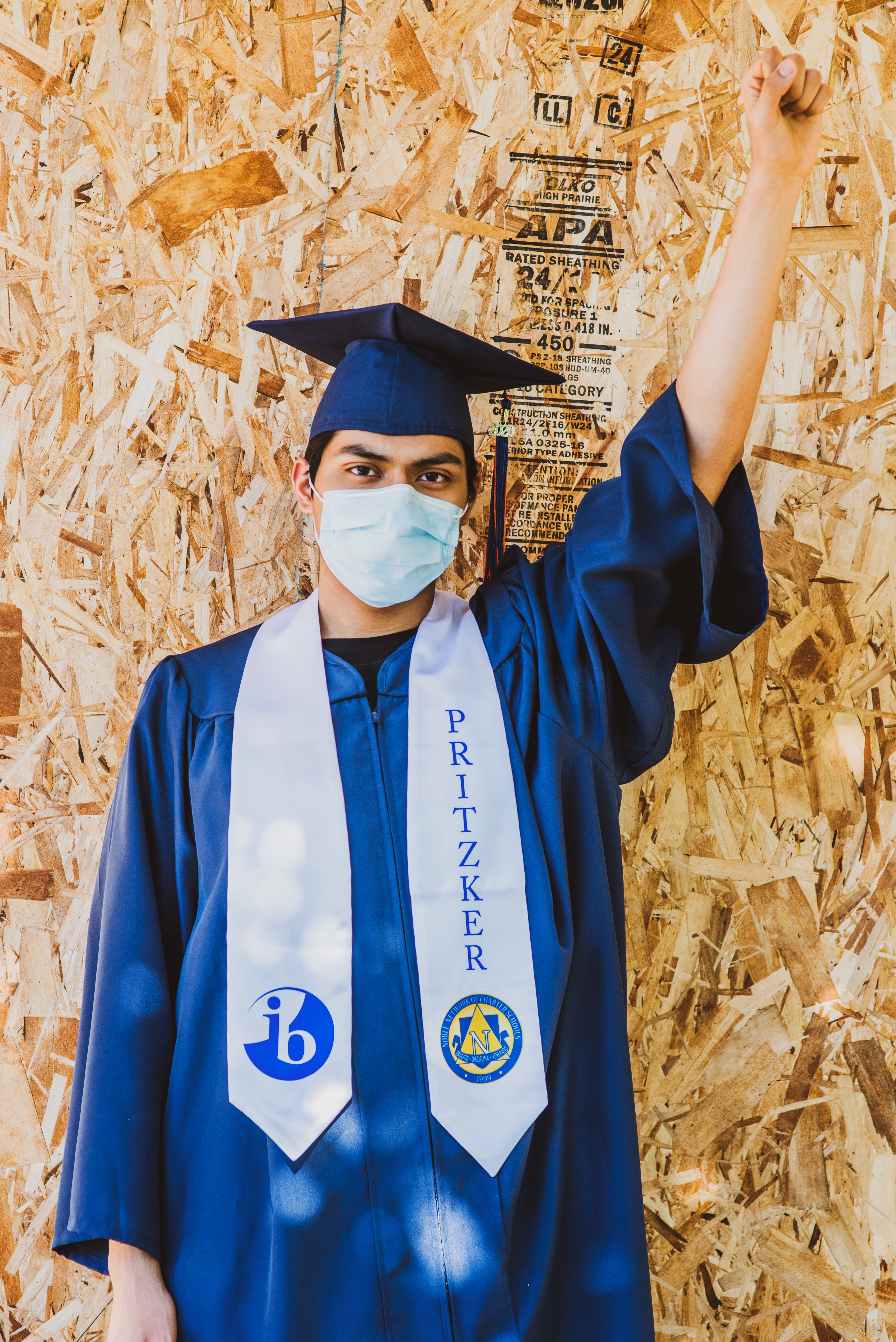 man in blue academic dress wearing blue academic hat