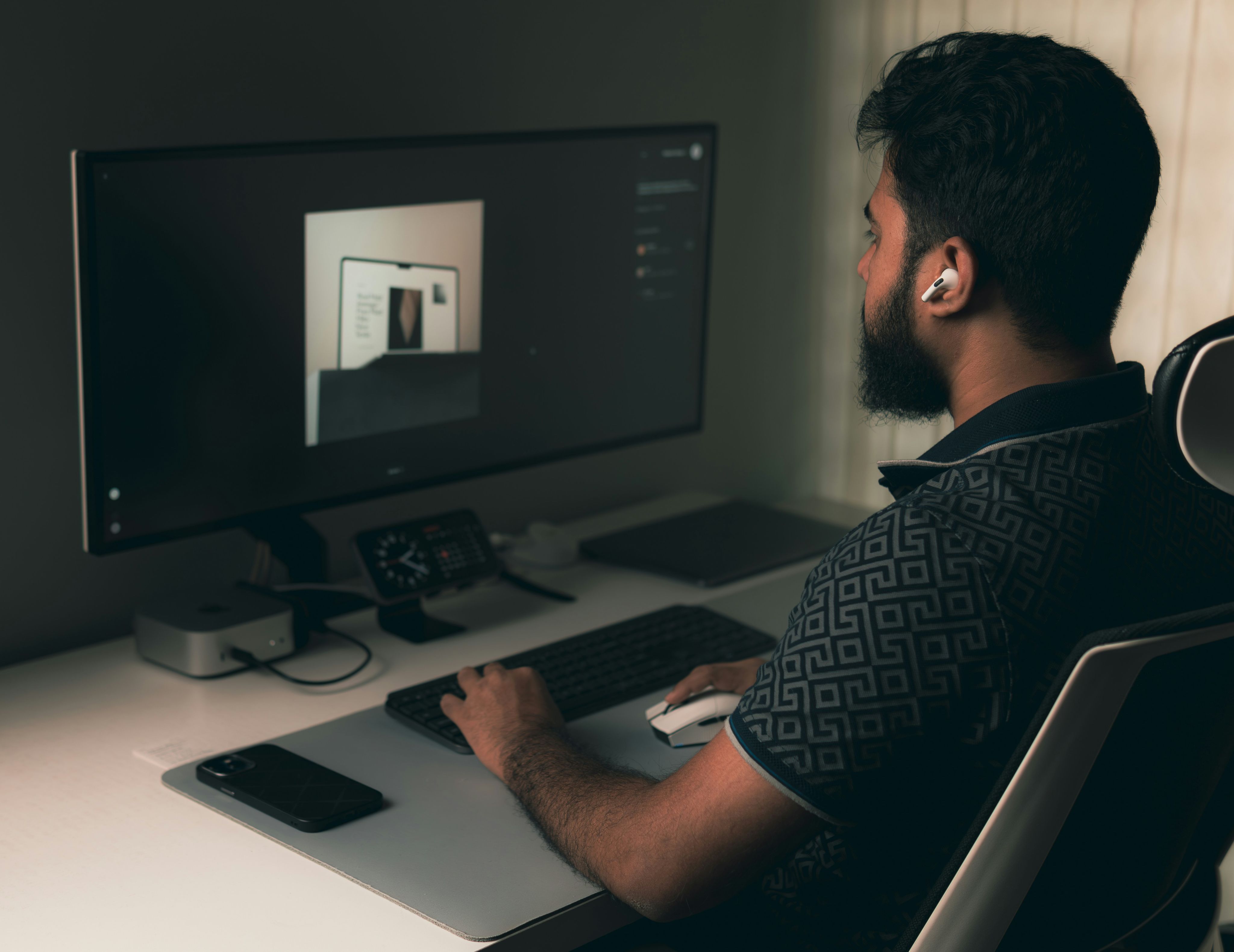 Man working on a computer at a desk.
