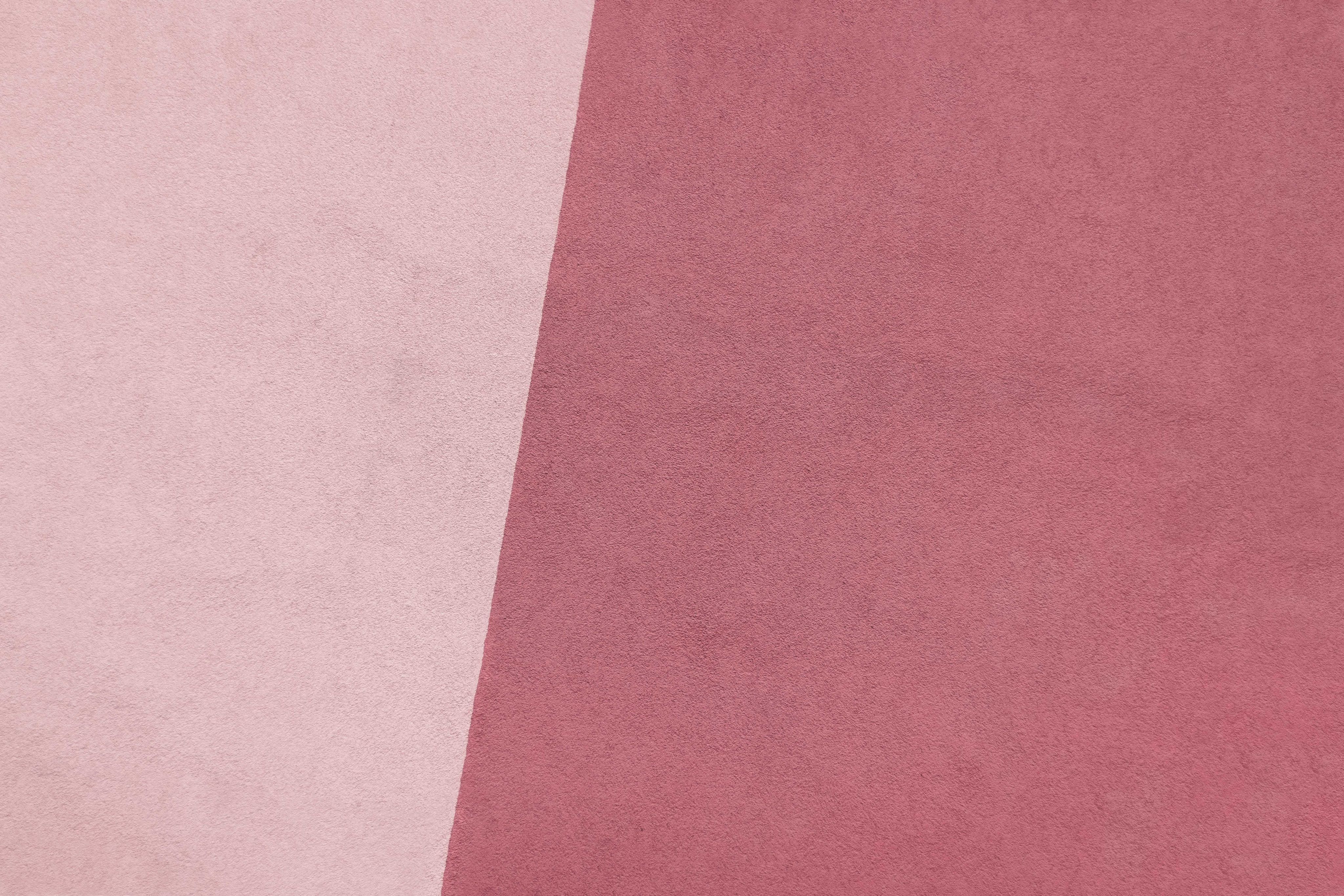 a close up of a pink and white background